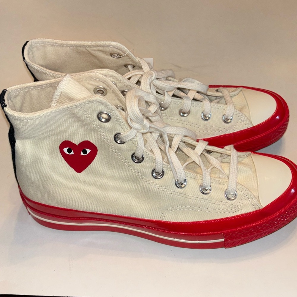 COMME des GARÇON/CONVERSE high top sneakers.